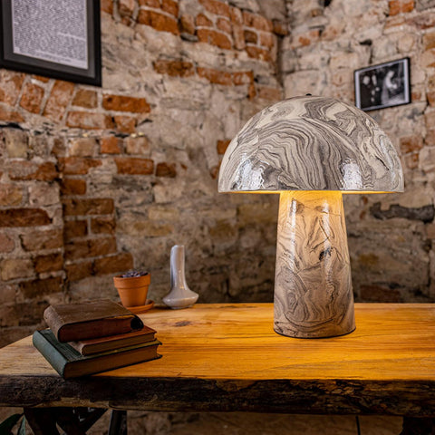 Decorative lamp on a wooden table with a brick wall background